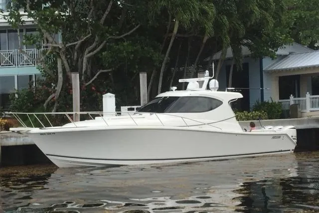  Yacht Photos Pics 2015 Jupiter 41 SB boat docked near waterfront homes and lush greenery.