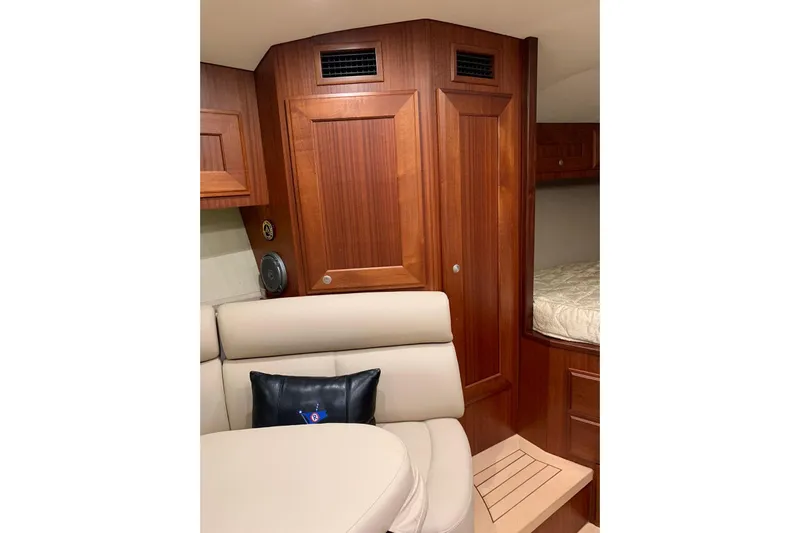  Yacht Photos Pics Interior of 2015 Jupiter 41 SB yacht with wooden cabinetry and beige seating.