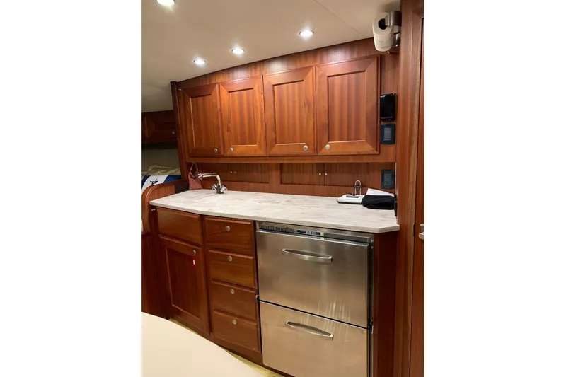  Yacht Photos Pics Luxurious wooden kitchen interior of 2015 Jupiter 41 SB yacht with modern appliances.