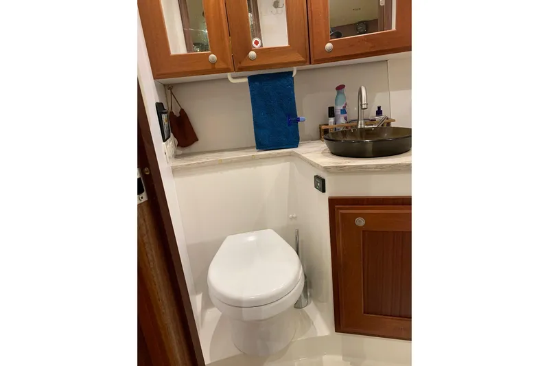  Yacht Photos Pics Bathroom interior of 2015 Jupiter 41 SB yacht with wooden cabinets and modern fixtures.