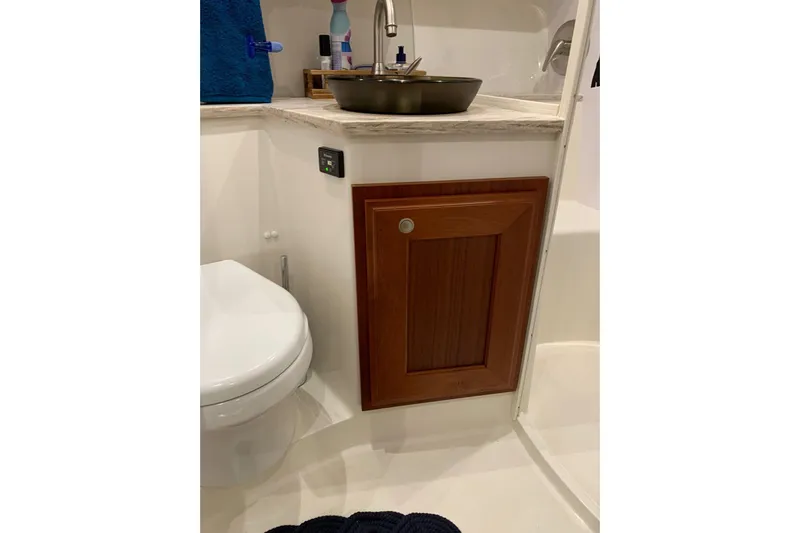  Yacht Photos Pics Bathroom interior of 2015 Jupiter 41 SB boat with wooden cabinet and modern fixtures.