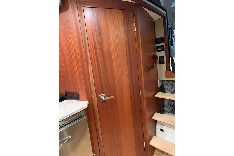  Yacht Photos Pics Interior of 2015 Jupiter 41 SB yacht with wooden door and staircase.