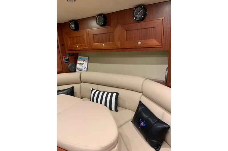  Yacht Photos Pics Luxurious interior of 2015 Jupiter 41 SB yacht with leather seating and wooden cabinets.