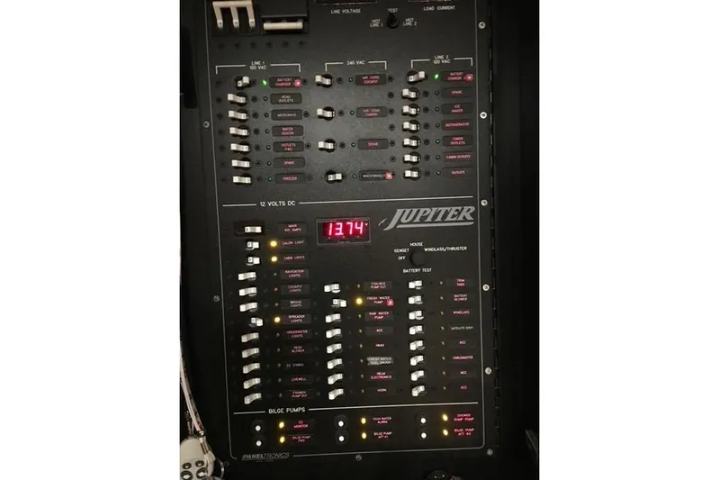  Yacht Photos Pics Control panel of a 2015 Jupiter 41 SB boat with switches and digital display.