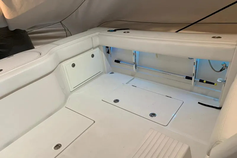  Yacht Photos Pics Interior of a 2015 Jupiter 41 SB boat with white seating and storage compartments.