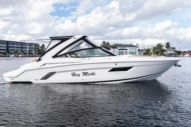  Yacht Photos Pics 2015 Cruisers Yachts 338 Bow Rider on water, sleek design, modern waterfront backdrop.