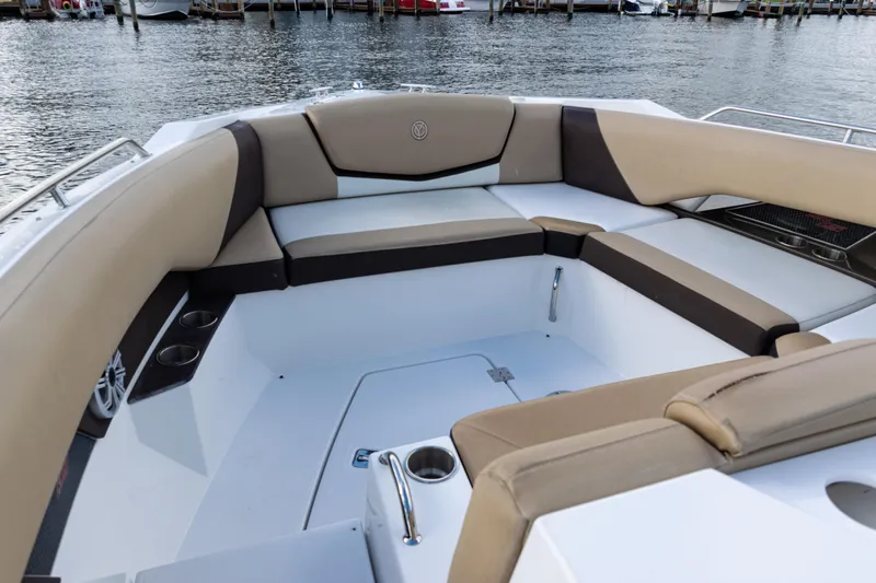  Yacht Photos Pics 2015 Cruisers Yachts 338 Bow Rider interior with beige seating and cup holders.