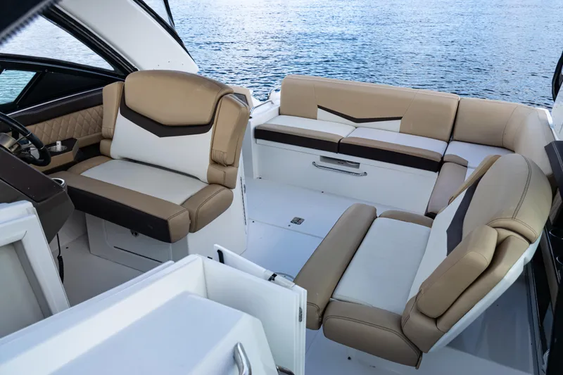  Yacht Photos Pics 2015 Cruisers Yachts 338 Bow Rider interior with beige seating, overlooking water.
