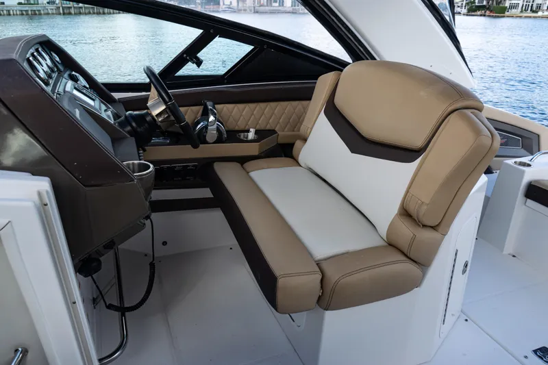  Yacht Photos Pics 2015 Cruisers Yachts 338 Bow Rider helm with tan leather seating and modern controls.