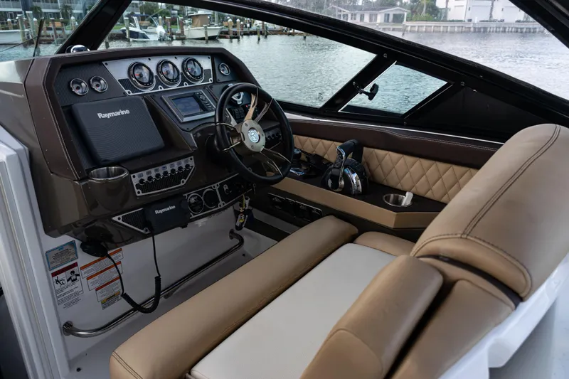  Yacht Photos Pics 2015 Cruisers Yachts 338 Bow Rider helm with Raymarine electronics and luxurious seating.