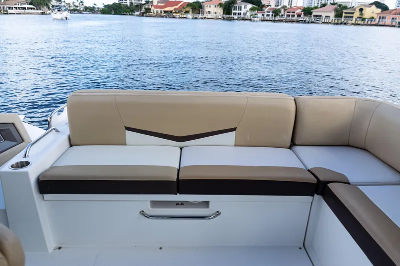  Yacht Photos Pics 2015 Cruisers Yachts 338 Bow Rider interior with beige seating, overlooking calm waters.