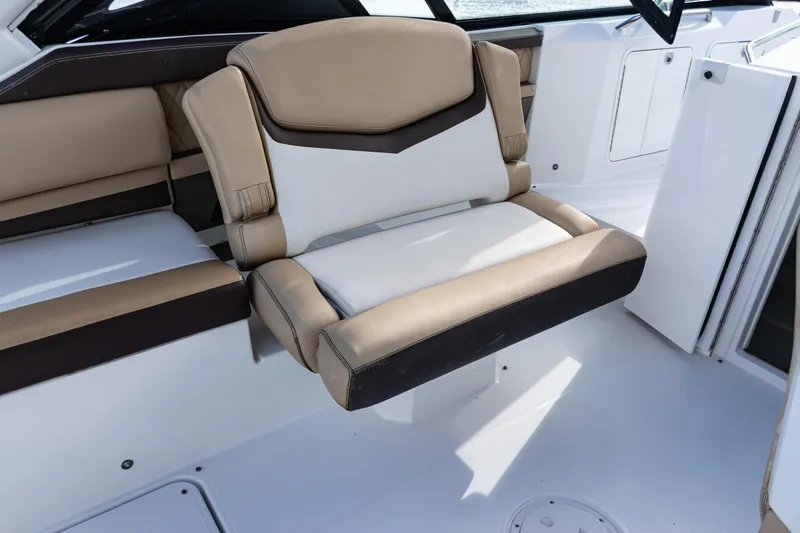  Yacht Photos Pics 2015 Cruisers Yachts 338 Bow Rider interior seating, featuring beige and white upholstery.
