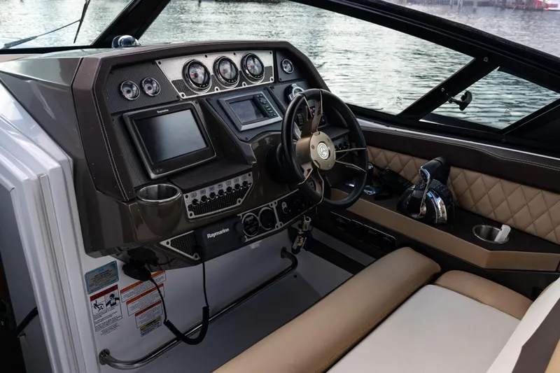  Yacht Photos Pics 2015 Cruisers Yachts 338 Bow Rider dashboard with steering wheel and navigation controls.