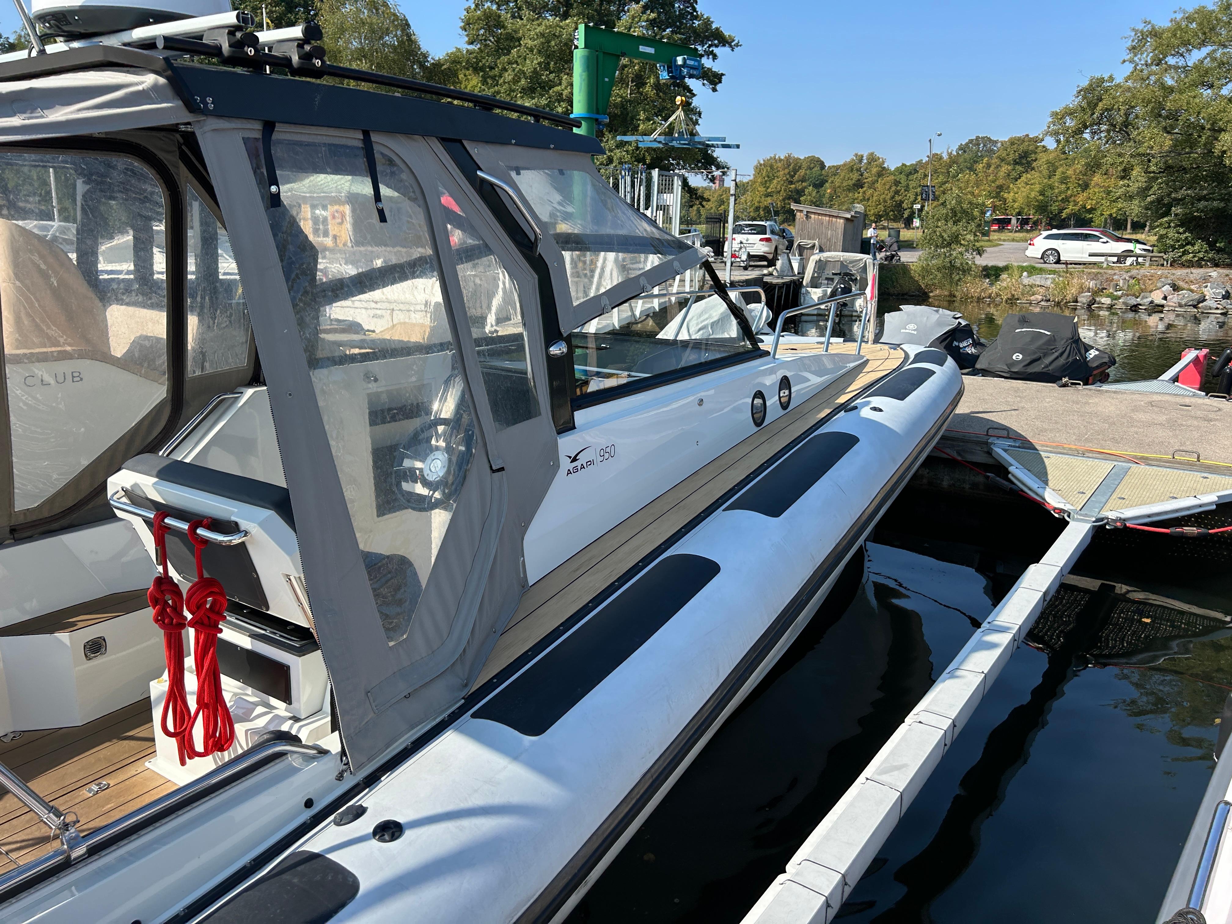 2019 Agapi 950 boat docked at marina, featuring sleek design and modern canopy.