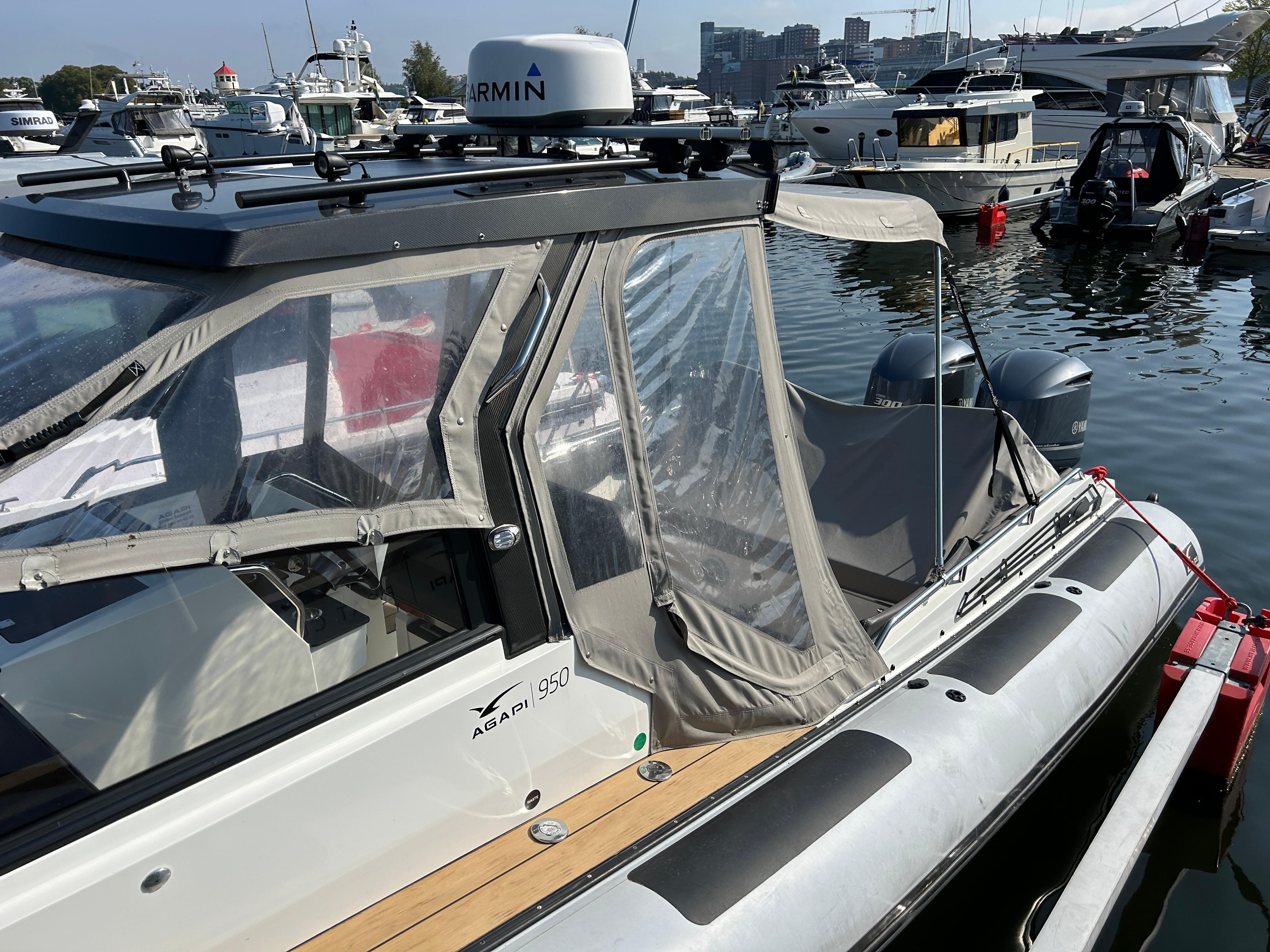 2019 Agapi 950 boat docked in marina, featuring clear canopy and modern design.
