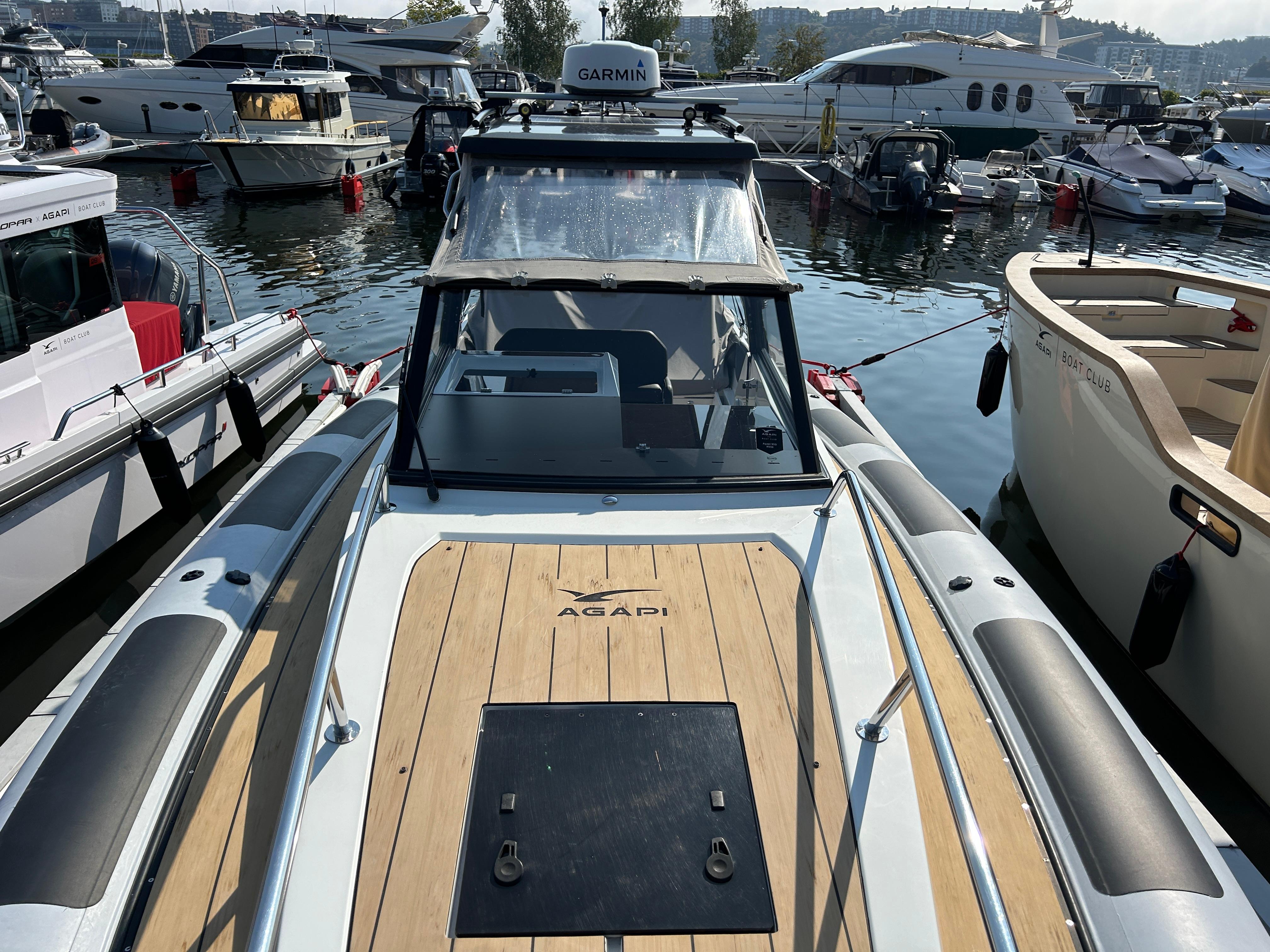Agapi 950 boat, 2019 model, docked among other vessels in a marina.