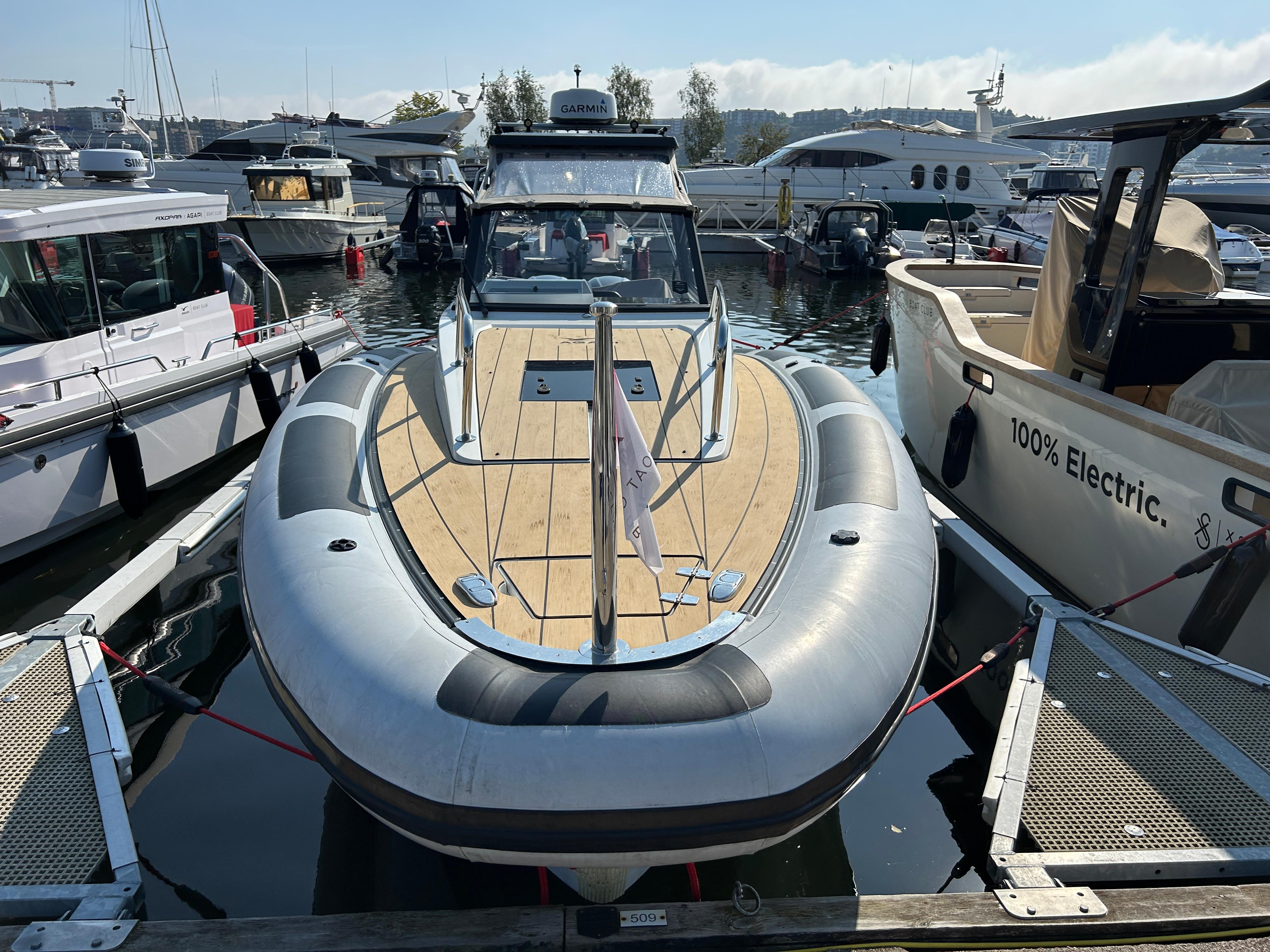 Agapi 950 boat, 2019 model, docked among other vessels in a marina.