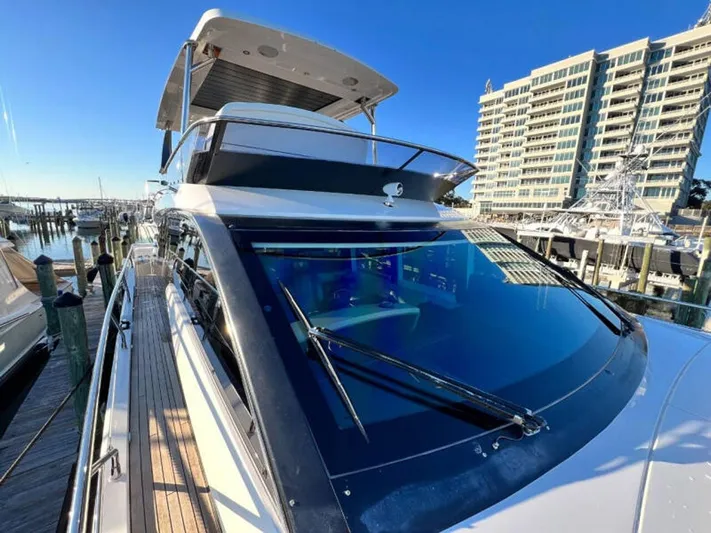 Blind Date Yacht Photos Pics 2020 Fairline Squadron 68 yacht docked at marina, modern design, clear blue sky.