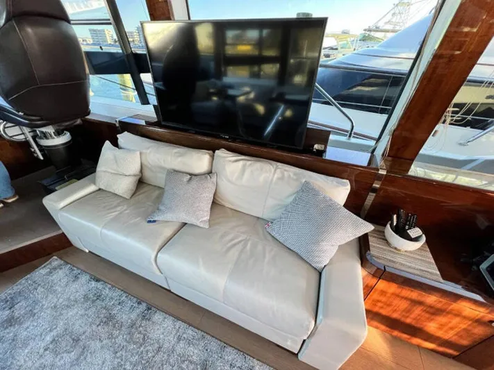 Blind Date Yacht Photos Pics Luxurious interior of 2020 Fairline Squadron 68 yacht with leather sofa and large TV.