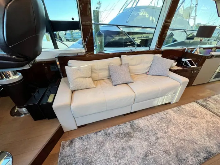 Blind Date Yacht Photos Pics Luxurious interior of 2020 Fairline Squadron 68 yacht with elegant white sofa and cushions.
