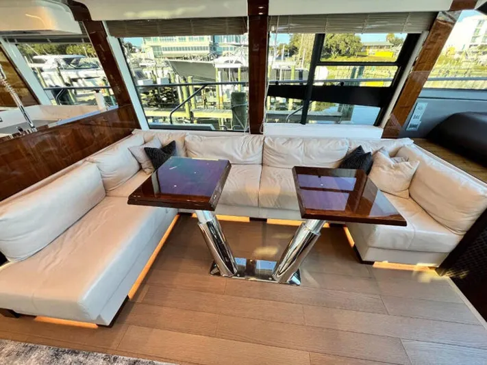 Blind Date Yacht Photos Pics Luxurious interior of 2020 Fairline Squadron 68 yacht with plush seating and elegant tables.