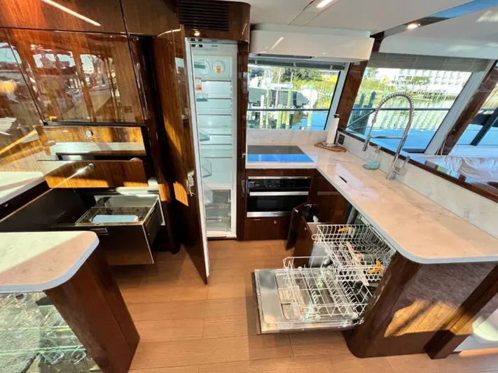 Blind Date Yacht Photos Pics Luxurious kitchen interior of 2020 Fairline Squadron 68 yacht with modern appliances.