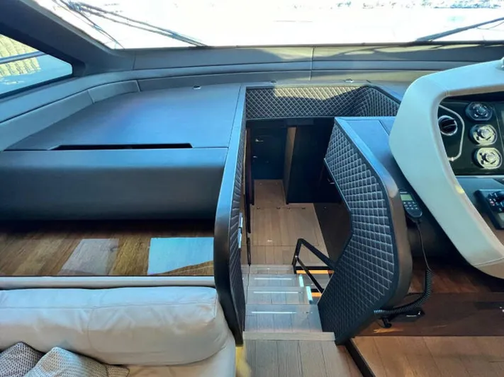 Blind Date Yacht Photos Pics Interior of 2020 Fairline Squadron 68 yacht, featuring modern helm and staircase.