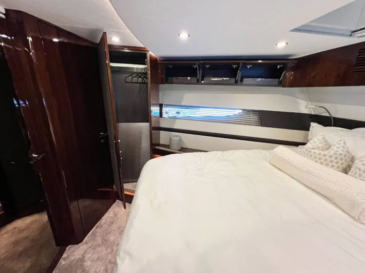 Blind Date Yacht Photos Pics Luxurious bedroom interior of 2020 Fairline Squadron 68 yacht with elegant wood finishes.