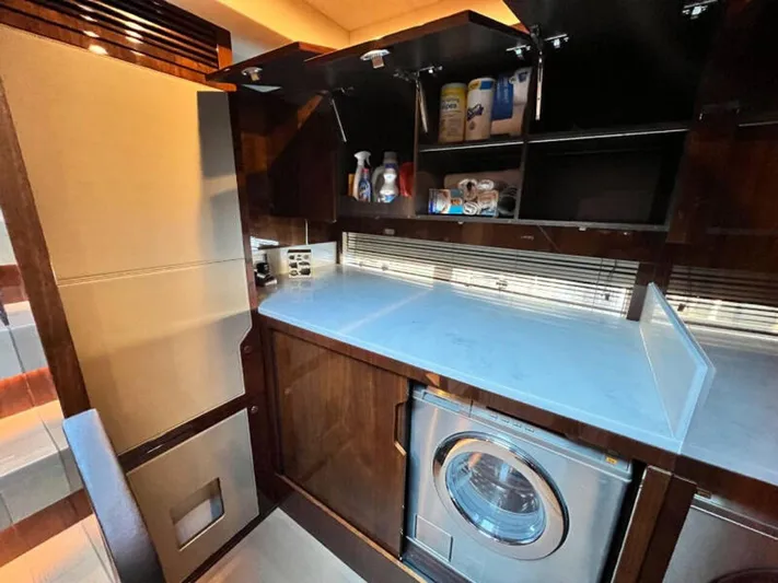 Blind Date Yacht Photos Pics Laundry area in 2020 Fairline Squadron 68 yacht with washer and storage cabinets.