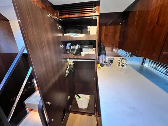 Blind Date Yacht Photos Pics Interior of 2020 Fairline Squadron 68 yacht with open wooden cabinet and countertop.