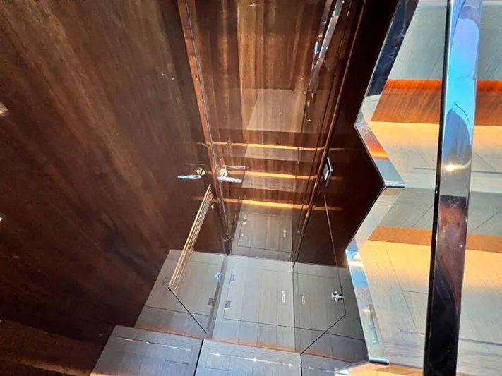 Blind Date Yacht Photos Pics Luxurious interior of 2020 Fairline Squadron 68 yacht, featuring sleek wood and glass elements.