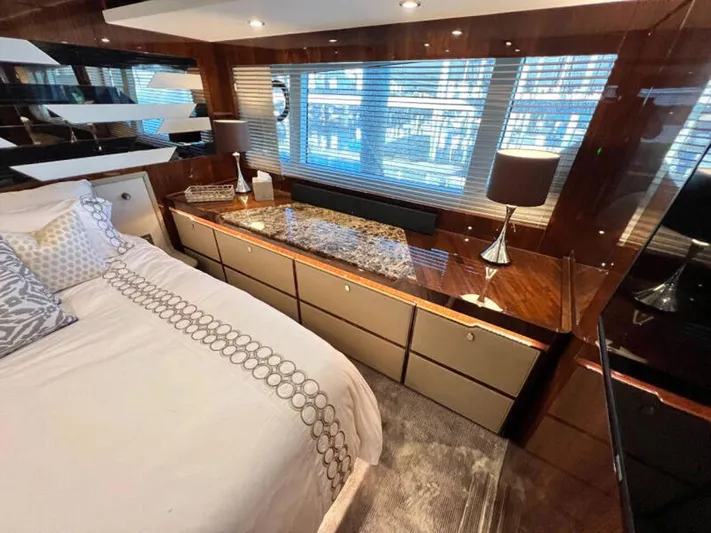 Blind Date Yacht Photos Pics Luxurious bedroom interior of 2020 Fairline Squadron 68 yacht with elegant decor and ample natural light.