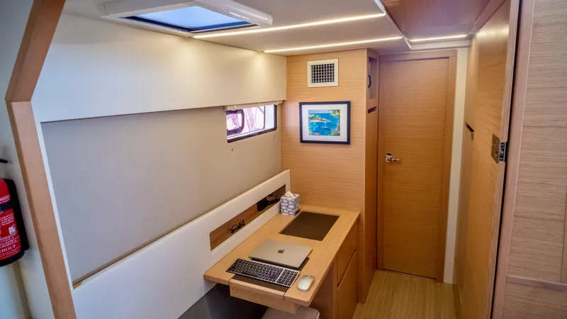 Muse Yacht Photos Pics Interior of 2019 Nautitech 40 Open with desk and laptop.