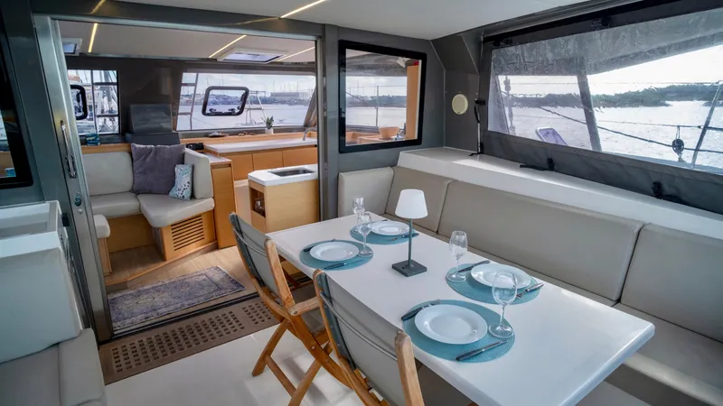 Muse Yacht Photos Pics Interior of 2019 Nautitech 40 Open with dining table and sofa.