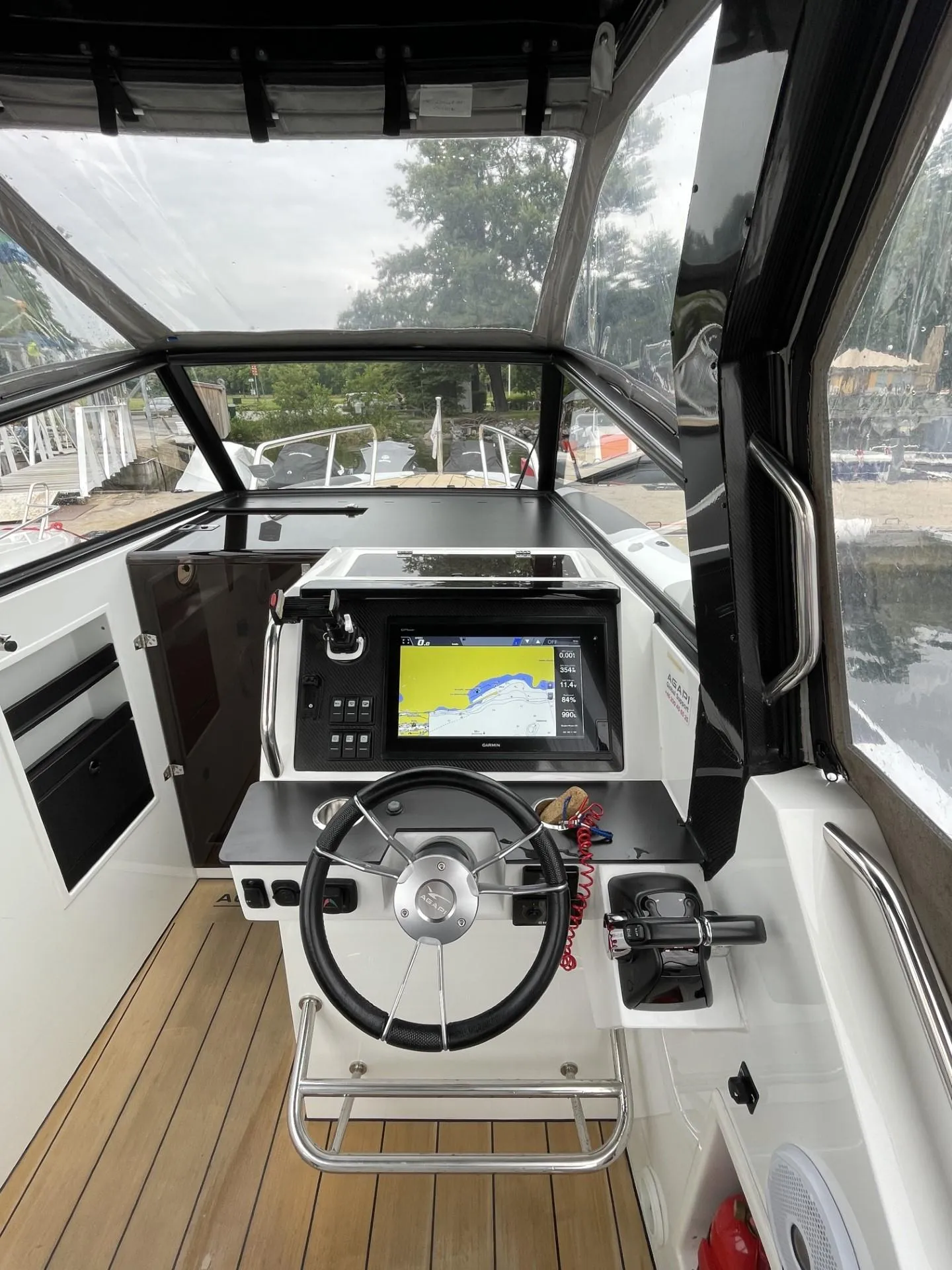 2019 Agapi 950 boat cockpit with modern navigation system and steering wheel.