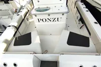 2023 Aquila 28 Molokai boat interior with seating and storage, featuring "PONZU" text.