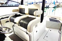 2023 Aquila 28 Molokai boat interior with dual seating and helm, docked at marina.