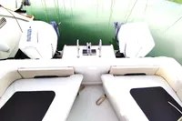 2023 Aquila 28 Molokai boat with dual outboard engines and cushioned seating.