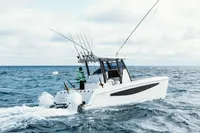 2023 Aquila 28 Molokai boat on open sea, equipped for fishing.