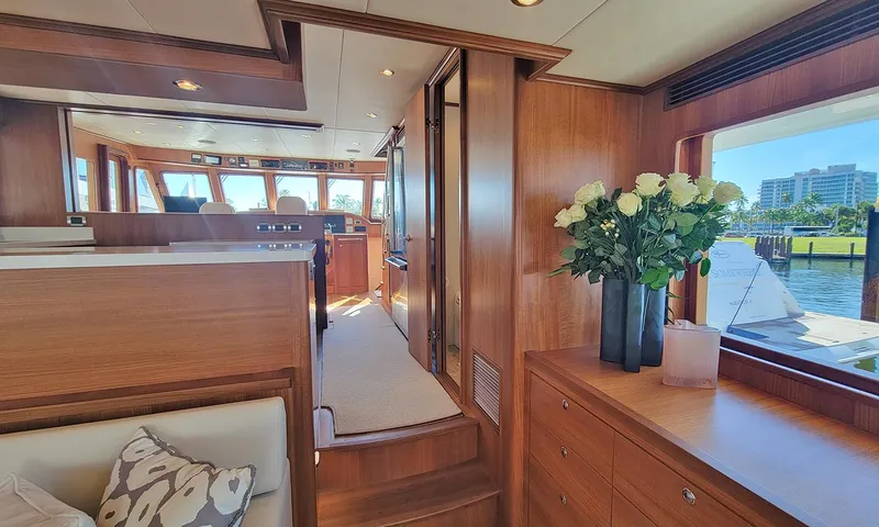 Our Way III Yacht Photos Pics Luxurious interior of 2023 Outer Reef Yachts 720 Motoryacht with elegant wood finish and floral decor.