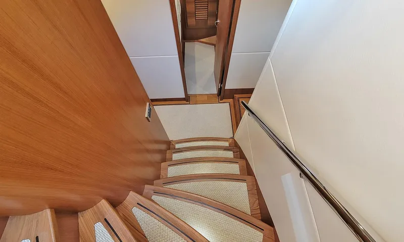Our Way III Yacht Photos Pics Staircase inside 2023 Outer Reef Yachts 720 Motoryacht, featuring elegant wood finish.