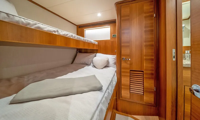 Our Way III Yacht Photos Pics 2023 Outer Reef Yachts 720 Motoryacht cabin with wooden interior and bunk beds.