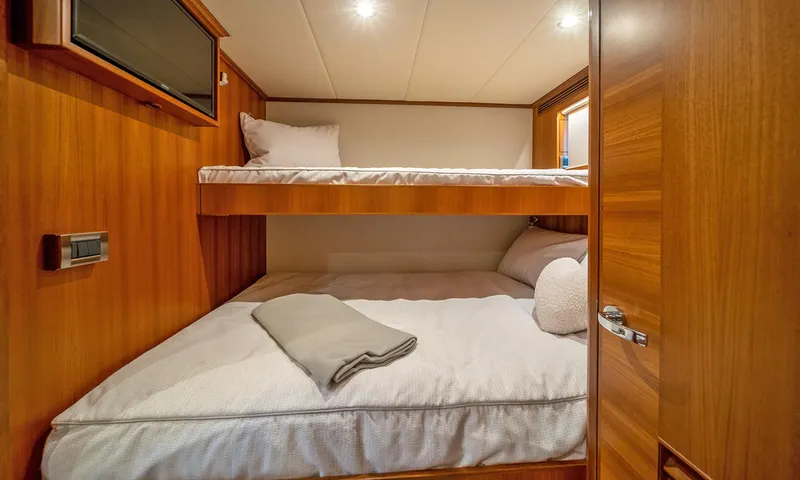 Our Way III Yacht Photos Pics 2023 Outer Reef Yachts 720 Motoryacht cabin with cozy wooden bunk beds.