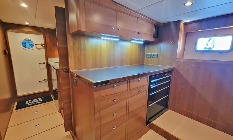 Our Way III Yacht Photos Pics 2023 Outer Reef Yachts 720 Motoryacht interior with wooden cabinetry and modern lighting.