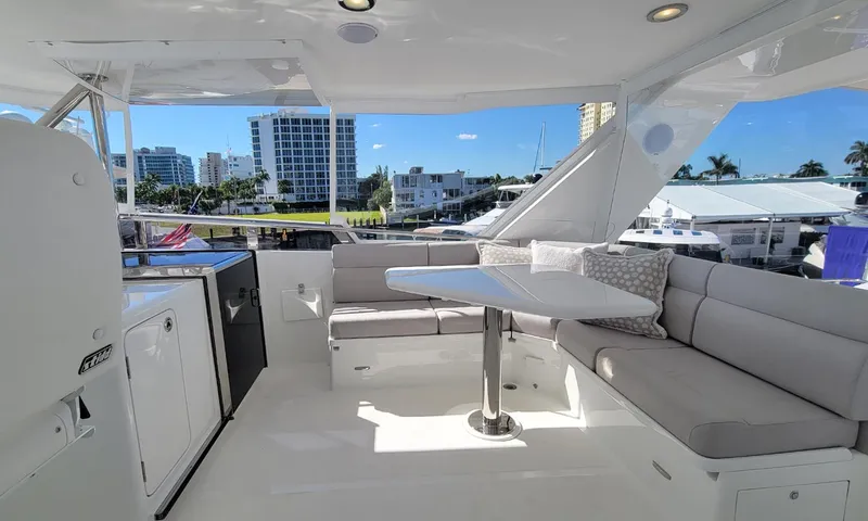 Our Way III Yacht Photos Pics 2023 Outer Reef Yachts 720 Motoryacht, spacious deck with seating and table, marina view.