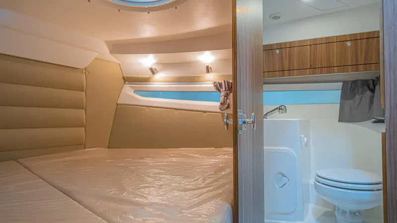  Yacht Photos Pics 2024 Skamander 920 Explorer MAX cabin interior with bed and compact bathroom.