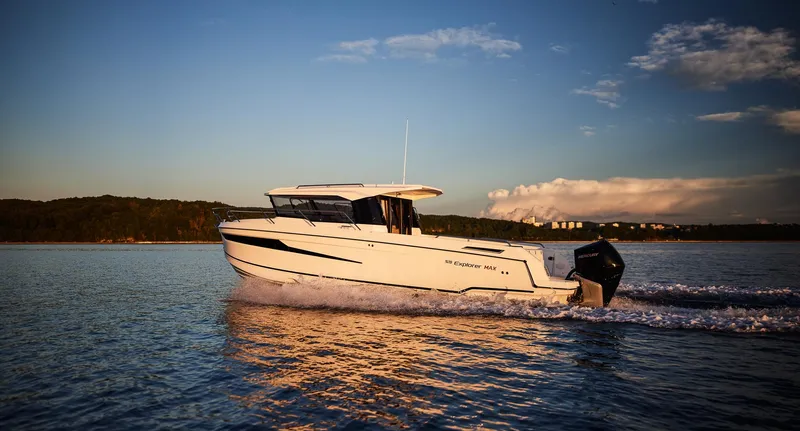  Yacht Photos Pics 2024 Skamander 920 Explorer MAX cruising on a serene lake at sunset.