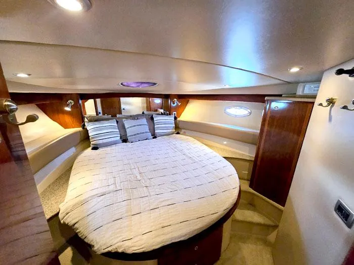  Yacht Photos Pics Luxurious cabin interior of 2007 Meridian 411 Sedan yacht with cozy bed and ambient lighting.