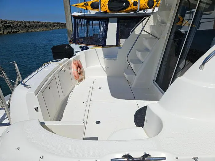 Yacht Photos Pics 2007 Meridian 411 Sedan yacht deck with stairs and life preserver, docked by the water.