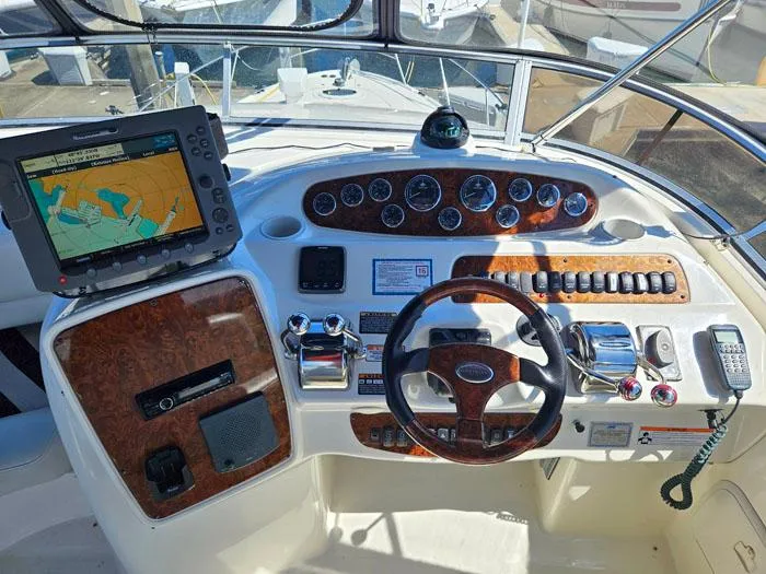  Yacht Photos Pics 2007 Meridian 411 Sedan helm with navigation system and wood-accented controls.